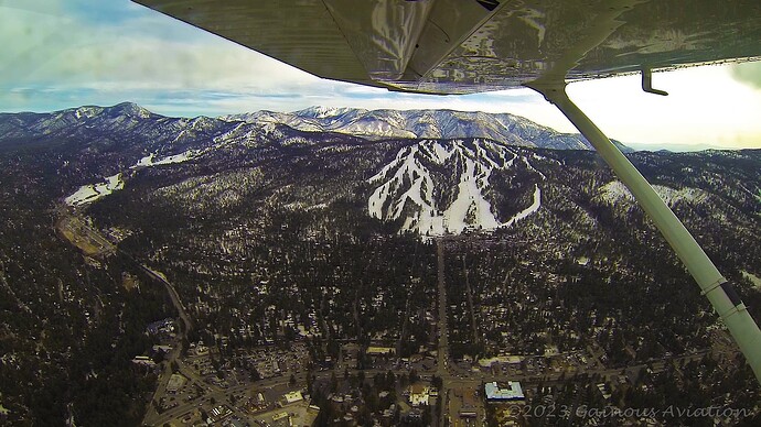 Downwind departure (Rwy 8) and at 8500 feet MSL with Snow Summit ski resort in view.