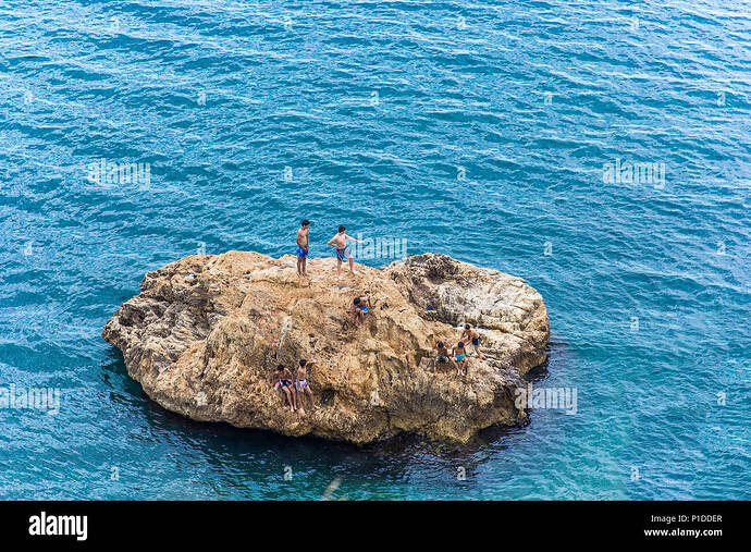 antalya-turkey-19-may-2018-large-stone-in-the-mediterranean-children-bathe-and-dive-from-the-stone-antalya-turkey-P1DDER